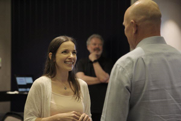 Smiling woman facing her colleague