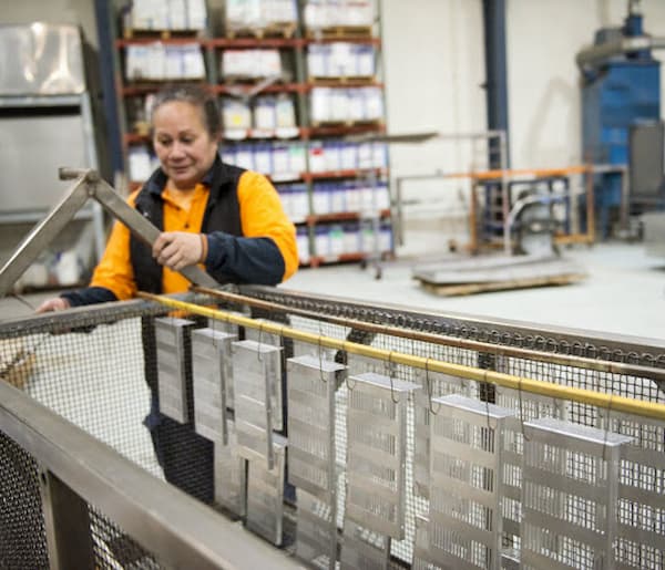 Lady worker arranging the steels in the warehouse