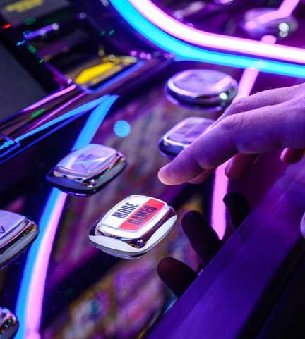 Hand pressing a button of a gaming machine