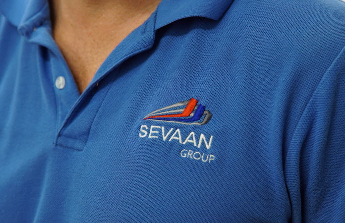 Man wearing a shirt with Sevaan Group logo