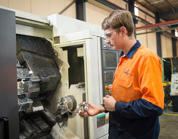 Man working using a machine inside a factory