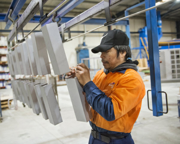 Man hanging up the steel bars in the warehouse