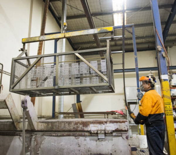 Man operating lifter equipment in the warehouse