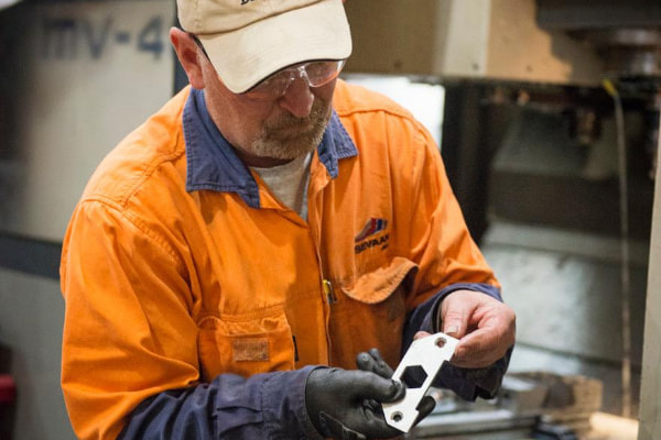 Man holiding a piece of metal