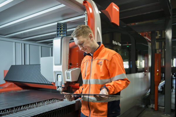 Man checking a metal from the machine