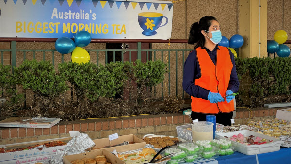 Woman wearing a face mask ready to assist in serving the food