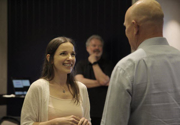 Smiling woman facing her colleague