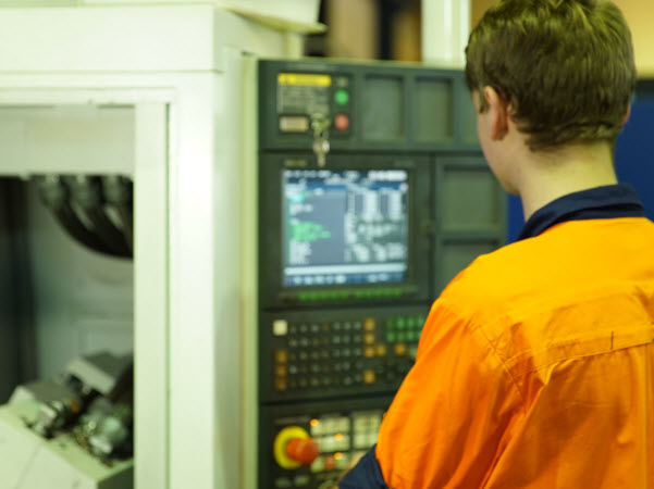 Employee operating a machine in a factory