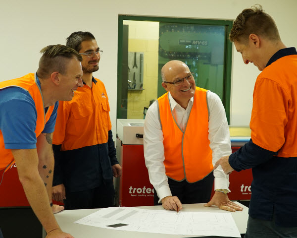 Team happily discussing plan inside the office